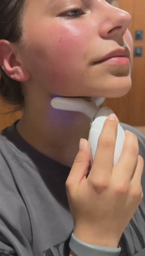 LED therapy device being used on woman's face